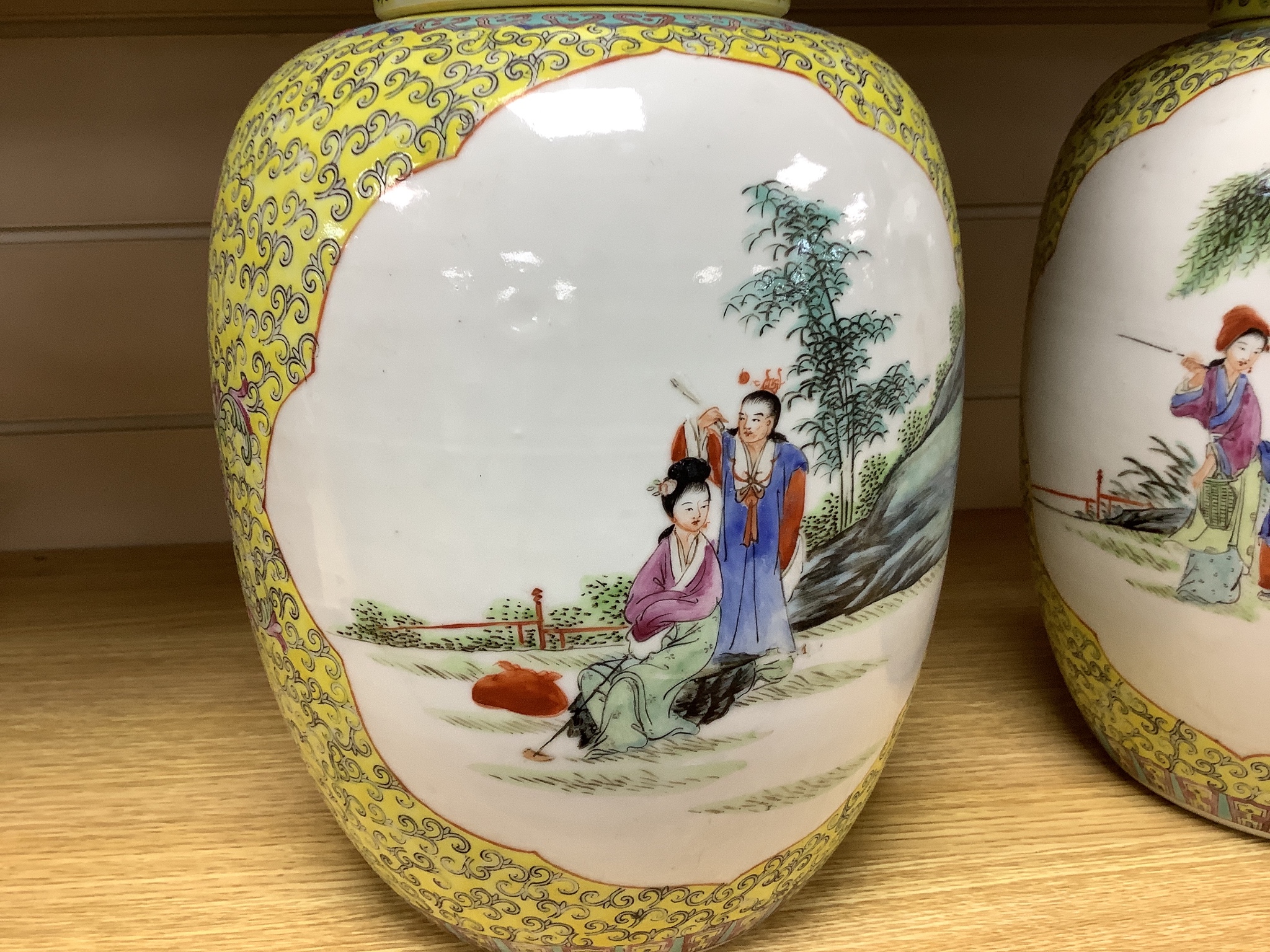 A pair of Chinese yellow ground vases and covers, height 30cm